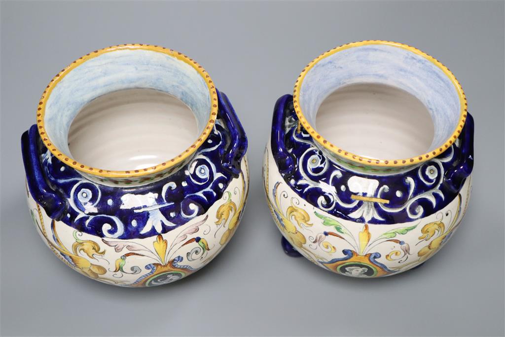 A pair of Urbino style Delft bulbous-bodied two-handled vases, each on three feet, height 18cm